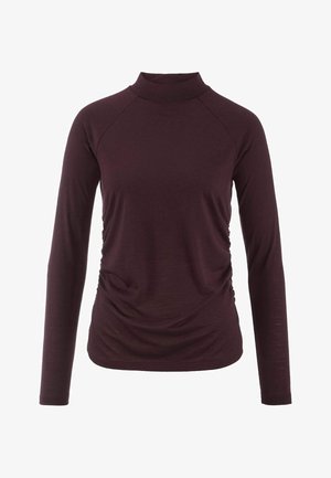 Langärmliges Turtleneck-Oberteil in tiefem Burgunderrot. Es zeichnet sich durch eine taillierte Passform mit gerafften Seitendetails aus und besteht aus weichem, leichtem Stoff.