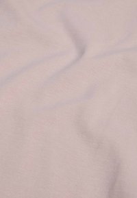 Tessuto rosa chiaro con una texture liscia e un sottile motivo a costine diagonali, drappeggiato per mostrare pieghe e increspature delicate.