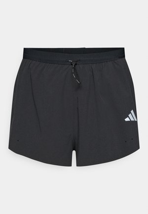 Shorts de sport noirs en tissu léger avec une taille à cordon de serrage et un logo à trois bandes blanches sur le côté inférieur gauche.