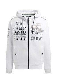 Sudadera blanca con cremallera hecha de algodón, que presenta texto impreso y gráficos. Incluye bolsillos y cordones en la capucha.