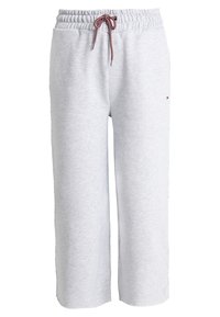 Helle graue Jogginghose aus weichem Material, mit einem elastischen Bund und Kordelzug sowie weitem Bein, ohne sichtbare Taschen.