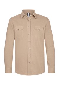 Beżowa koszula z długim rękawem wykonana z miękkiego materiału, z zapięciem na guziki z przodu, dwoma kieszeniami na wysokości klatki piersiowej oraz srebrnymi detalami.