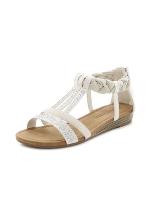 White sandal featuring braided straps, embellished with clear gems,  flat sole, textured material, and open toe design.