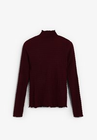 Burgundy long-sleeve top in textured fabric with a mock neck and scalloped hem. Features a relaxed fit and subtle pattern throughout.