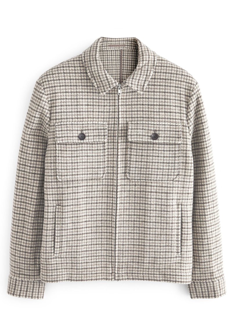 Houndstooth-mønstret jakke i grå og beige, med lynlås foran, to brystlommer med knapper og krave.