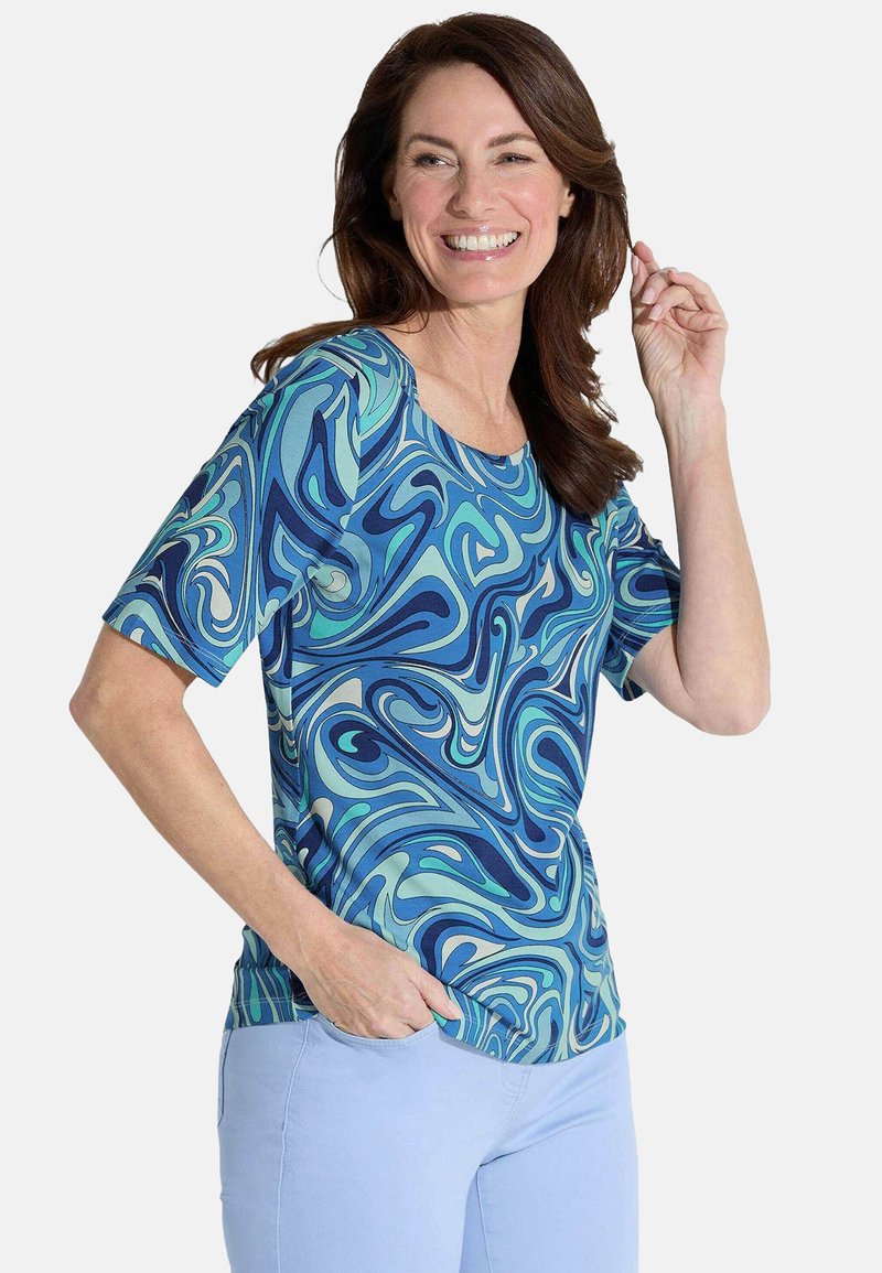 Korte mouwen top met een blauw en groen gespiraliseerd patroon. Gemaakt van gladde stof met een klassieke ronde halslijn en een relaxte pasvorm.