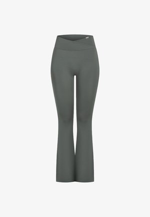 Schlank geschnittene Leggings in Dunkelgrün, aus dehnbarem Stoff. Sie verfügen über einen breiten, überkreuzten Bund und eine glatte, nahtlose Textur.