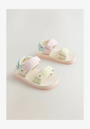 Sandali per bambini con suole morbide beige, cinturini a righe pastello in rosa, blu e giallo, con dettagli decorativi animali sulle chiusure.