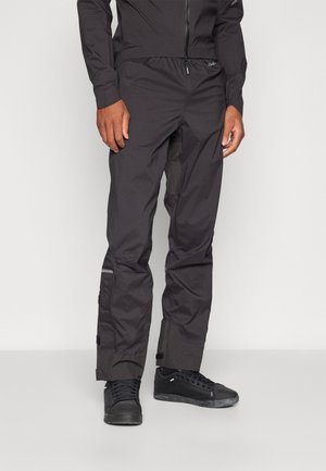 Black outdoor pants made of lightweight fabric. Features a stretchy waistband, zippered pockets, and reflective accents for visibility.