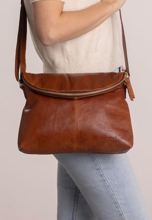 Brown leather crossbody bag with a zip closure, flat design, and a textured finish. Features an adjustable strap and a subtle logo detail.
