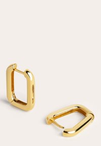 Pendientes de aro de metal dorado con forma cuadrada, que presentan una textura suave y un acabado brillante. Incluyen un cierre articulado para un ajuste seguro.
