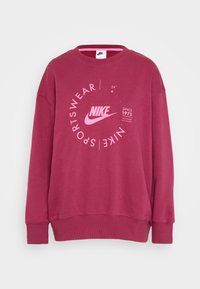 Nike sweatshirt i djuprosa, med rund halsringning och långa ärmar. Framsidan har en grafisk design med varumärkets logotyp och text, samt ribbad mudd vid ärmar och nederkant.