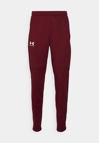 Mörkröda idrottsbyxor gjorda av mjukt, stretchigt tyg; elastisk midja; har logotyp på vänster ben; avsmalnande passform och ribbade mudd.