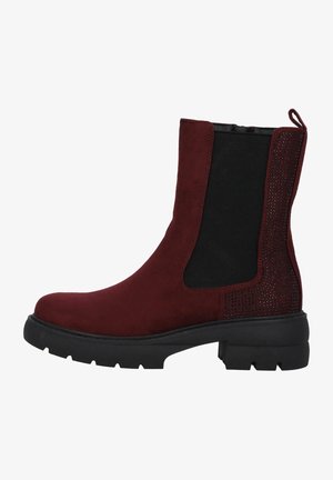 Bottines bordeaux avec une tige en daim, des panneaux latéraux élastiques et un accent noir texturé avec des clous métalliques sur le talon. Semelle épaisse noire.