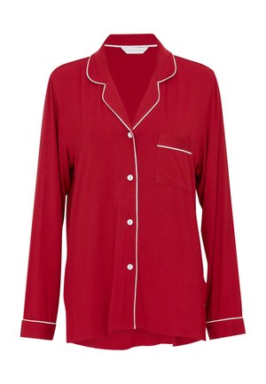 Camisa de pijama roja de manga larga con pasamanería blanca, cuello con muesca, bolsillo frontal y cierres de botón. Fabricada con un tejido suave y de forma relajada.