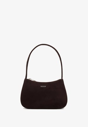 Pruunist seemisnahast kott, millel on kõver kuju, ühesainus õlavarre rihm ja peal oleva lukuga sulgur. Kaasas on väike hõbedane logo detail.