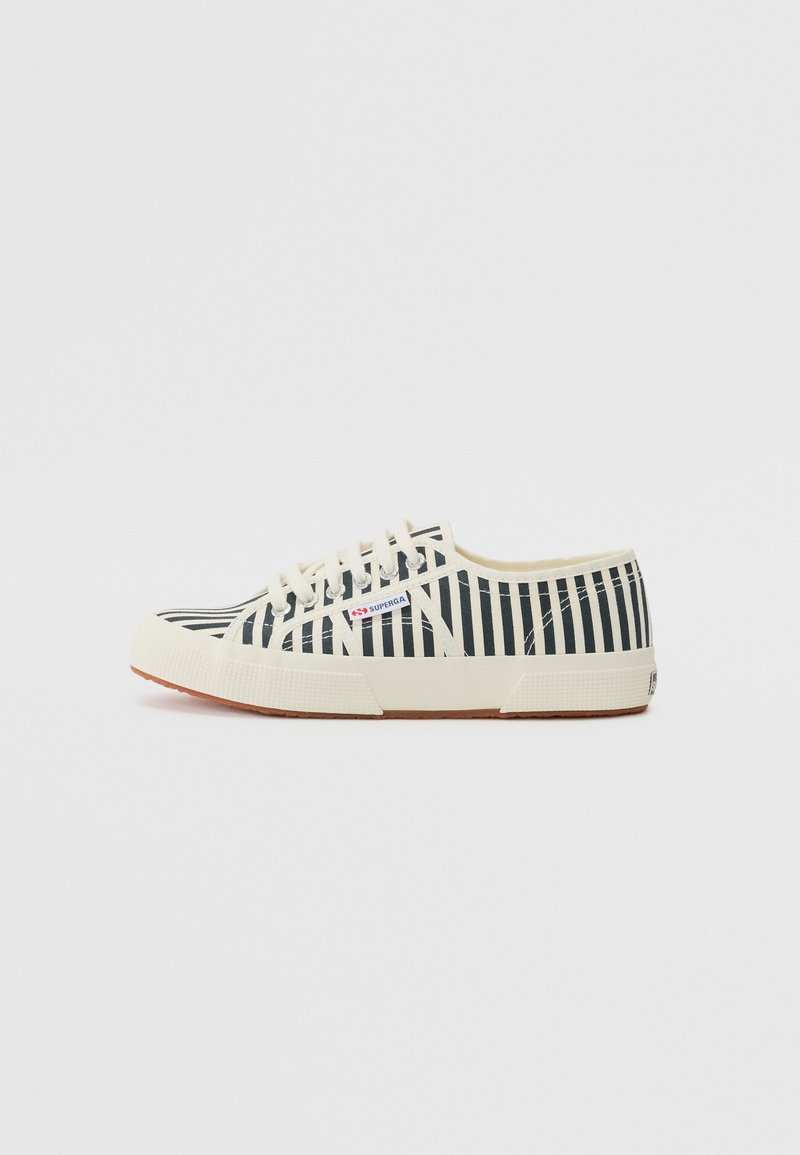 Canvas sneakers with a white and navy striped design, lace-up closure, rubber sole, and a textured cream-colored midsole.