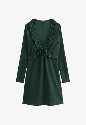 Donkergroene, geribbelde, gebreide jurk met lange mouwen, diepe V-hals, gerimpelde rand en strikdetail aan de voorkant onder de buste.