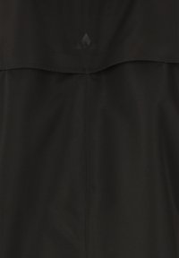 Black garment with a smooth texture and a loose fit. Features a lower panel and a subtle logo in a darker shade at the top.