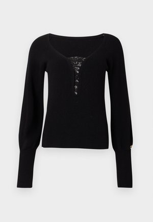 Black knitted sweater with a V-neck, featuring a lace insert at the neckline and slightly puffed long sleeves with cuff detailing.