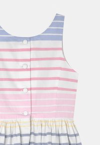 Pruhované šaty s modrou, růžovou a bílou barevnou paletou; mají výstřih do lodičky, zapínání na knoflíky a nařasenou sukni.