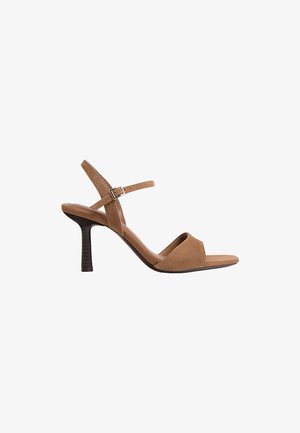 Brown suede heeled sandal with an open toe design, adjustable ankle strap, and a slender vertical heel with a textured finish.