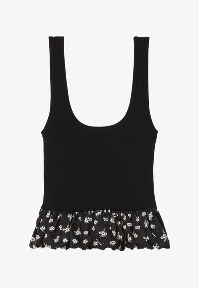 Débardeur noir avec un décolleté arrondi, présentant un ourlet volanté en tissu noir orné de petits motifs floraux blancs.