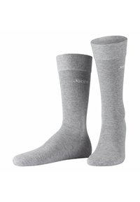 Calcetines de algodón grises con un puño acanalado y textura lisa. Presentan un bordado discreto en el costado. Longitud estándar de caña.