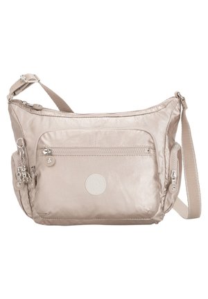 Beige nylon crossbody bag with a single adjustable strap, front zip pocket, logo patch, and decorative zipper pulls. Smooth, lightweight texture.