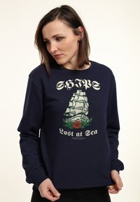 Felpa blu navy in cotone, con una stampa grafica di una nave a vela e fiori, con la scritta "Lost at Sea" in lettere crema.