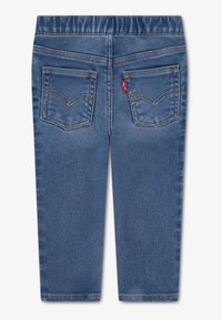 Blue denim jeans featuring an elastic waistband, two back pockets, and subtle golden stitching details. Smooth texture, slim fit.