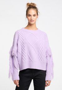 Lila gestrickter Pullover mit Kabel- und Diamantmustern, der Fransenakzente an den Ärmeln und einen gerippten Saum aufweist.