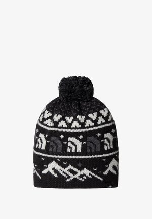 Berretto lavorato a maglia bianco e nero con pom-pom, caratterizzato da motivi di montagne e animali, texture morbida e vestibilità aderente.