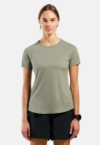 Olive green short-sleeve t-shirt made of soft fabric with a round neckline and raglan sleeves, featuring a small logo at the hem.