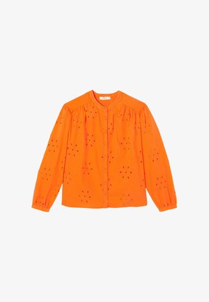 Blouse orange vif à manches longues avec encolure ronde, boutonnage devant, épaules froncées et motifs floraux ajourés sur l'ensemble.