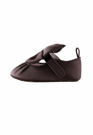 Soft fabric baby shoe in dark brown with a bow on top and a hook-and-loop strap for fastening, shown in side view.