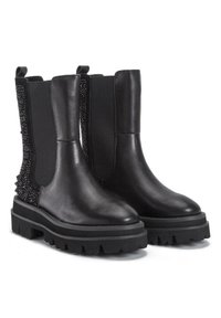Botas de cuero negras hasta el tobillo con paneles laterales elásticos, suelas de goma resistentes y un detalle de cuentas texturizadas en los lados exteriores.