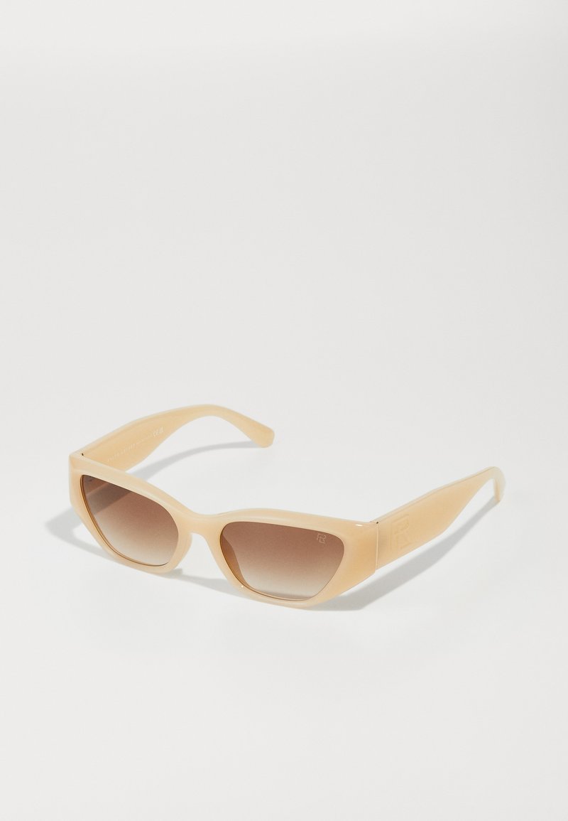 Beige sunglasses with a sleek, angular design. Gradient brown lenses and textured arms with subtle branding detail on the side.