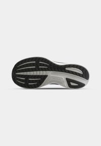 Black and gray athletic shoe sole with a textured rubber surface, featuring grooves and a distinct, curved design for traction.