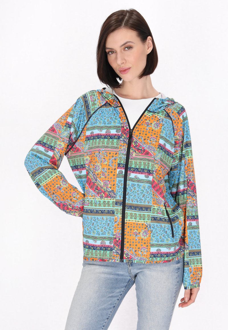 Giacca colorata con chiusura a zip e design a patchwork con motivi arancioni, blu, verdi e viola. Inclusi cappuccio e tasche.
