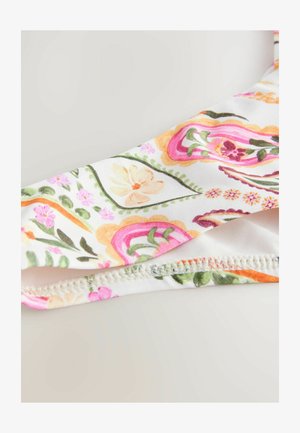 Bela tkanina s pisanimi cvetličnimi vzorci v roza, oranžni in zeleni barvi. Ima čipkast rob in zapleteno zasnovo po celotni površini.