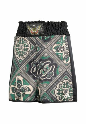 Boxer avec taille élastique, présentant un motif géométrique papillon et floral en vert, noir et crème avec un patch papillon.