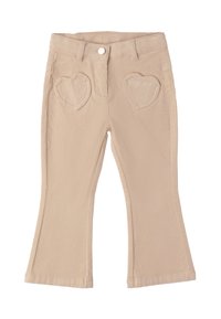 Pantalons en velours côtelé beige avec des jambes évasées et des poches avant en forme de cœur, dotés d'un bouton et de passants de ceinture à la taille.