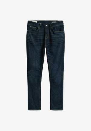 Jeans in denim blu scuro a taglio slim con tasche anteriori e posteriori, passanti per cintura e chiusura con bottone.