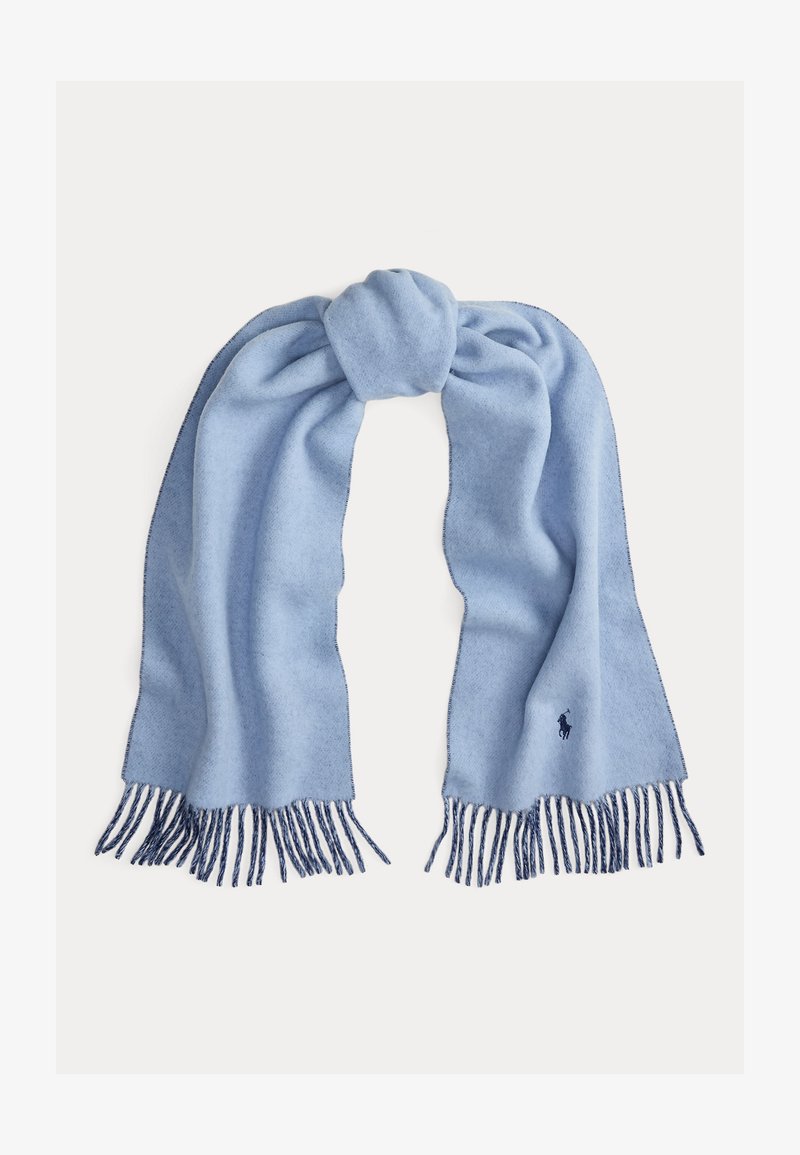 Světle modrý vlněný šátek s měkkou texturou, zakončený tmavě modrými třásněmi a vyšívaným logem na jednom konci.