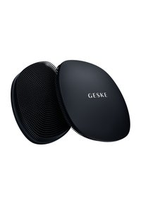 Black hairbrush featuring a rounded oval shape, textured rubber bristles, and a smooth matte finish. Logo "GESKE" printed on top.