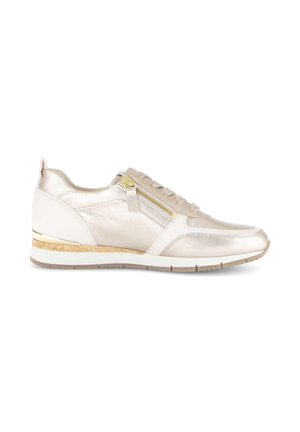 Beige and white low-top sneaker with side zipper, lace-up front, cork and rubber sole, and metallic gold detailing on heel.