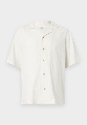 Chemise blanche à manches courtes avec col camp et cinq boutons beige centrés à l'avant.