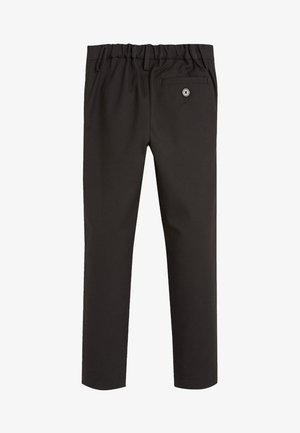 Pantalons noirs ajustés avec une taille élastique. Comprend une poche arrière unique avec un bouton. Tissu lisse, sans motifs ou accents visibles.