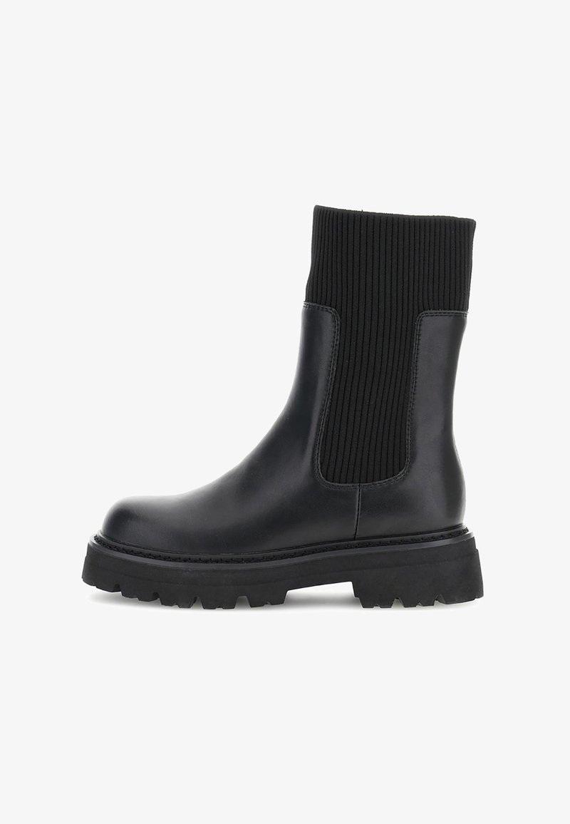 Black ankle boot with a smooth leather body and ribbed textile upper. Features a chunky rubber sole for traction and stability.